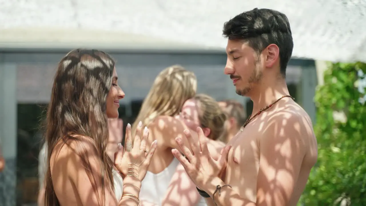 Beautiful Girl and Guy praying in front of each other while she is looking up to him