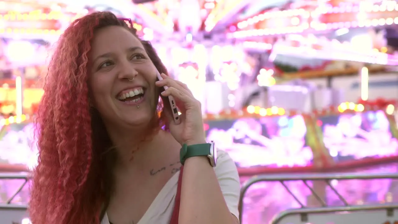 woman talking on smartphone at the fair