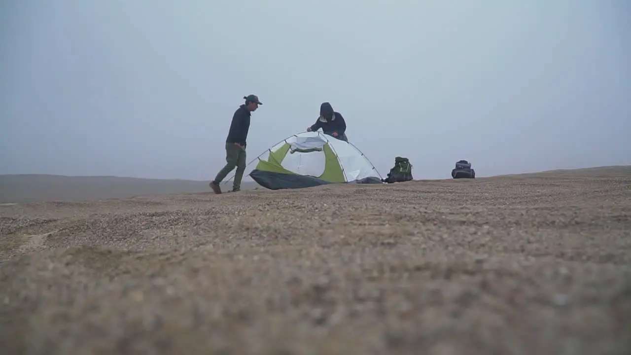 Tilt Shot Of Camper Setting Tent For Camping In Lima Desert Peru