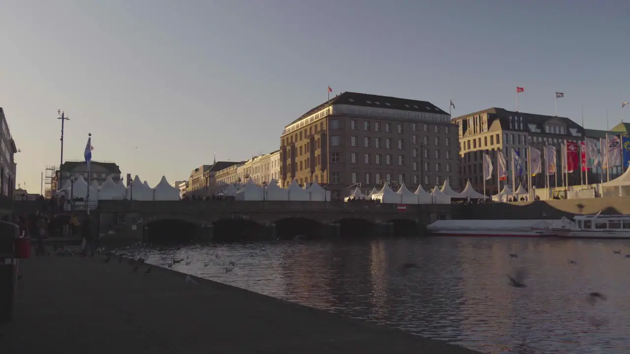 People enjoying the weather at a Christmas market at Binnenalster in Hamburg Germany in Dec 2019