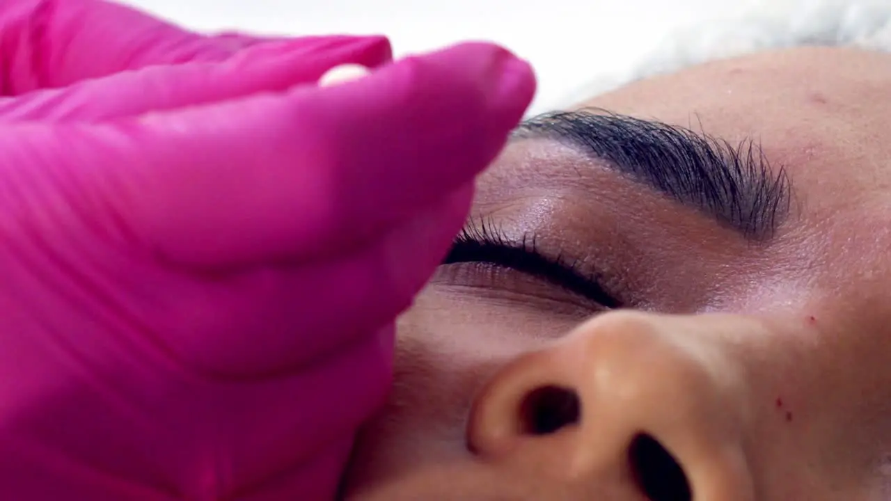 Latina woman getting Botox injections close up face