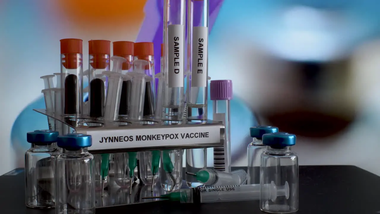 Glass test tubes with samples of Jynneous Monkeypox vaccine are being taken off the metal rack