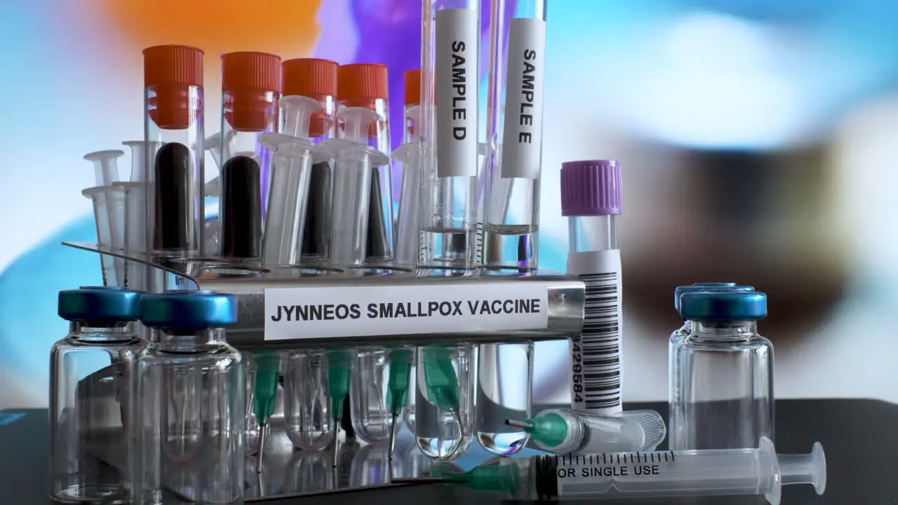 A close look at a metal tube rack labelled Jynneous Smallpox Vaccine