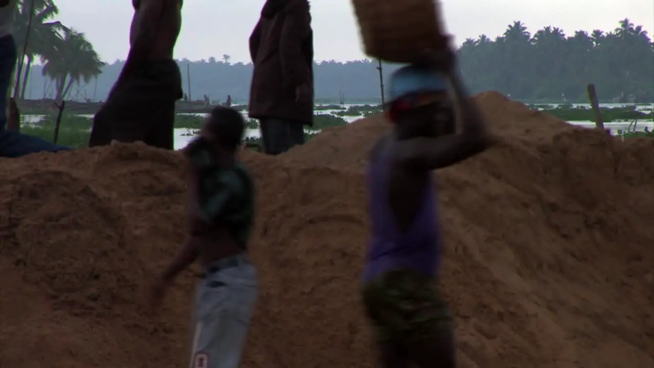 Man carrying a basket of Sand