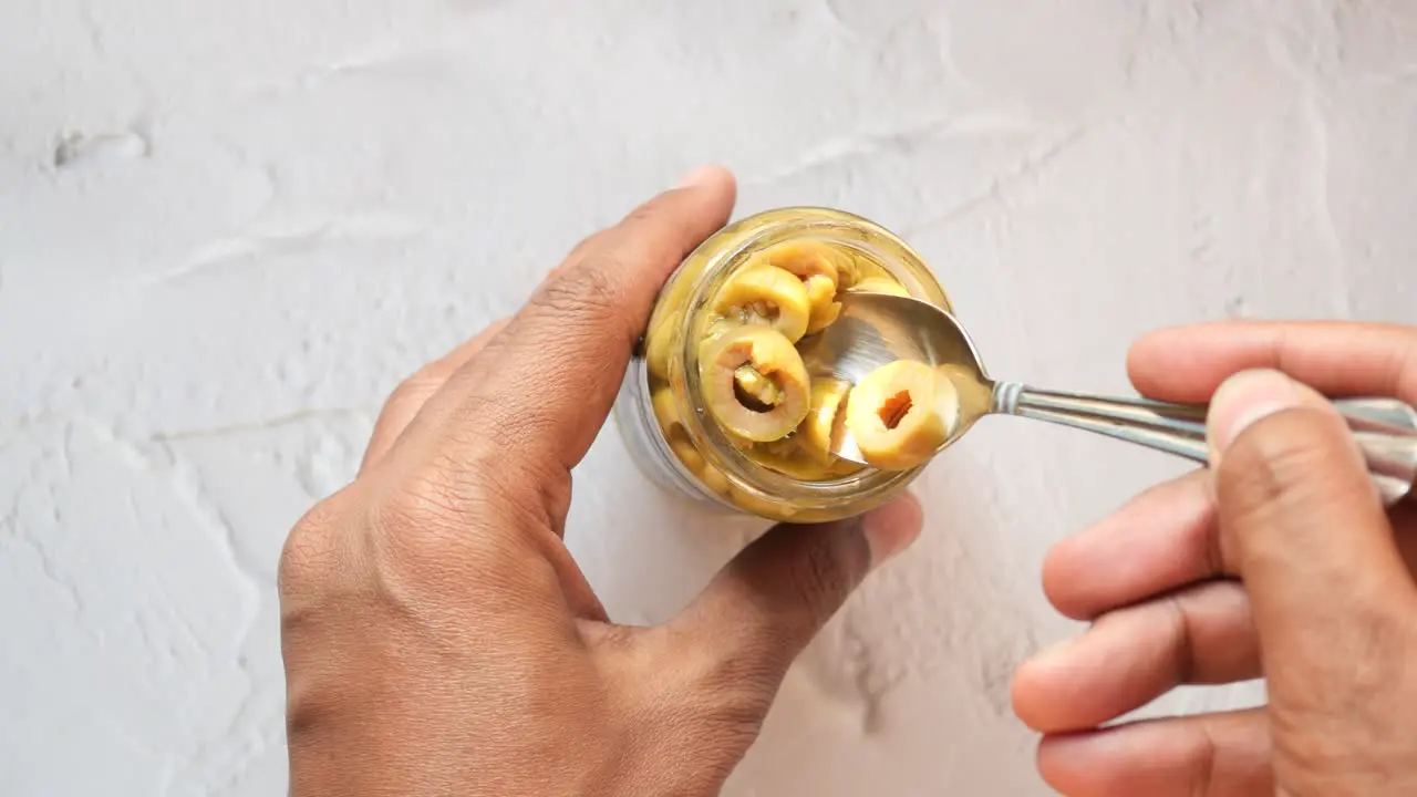 Holding a jar of olive top view