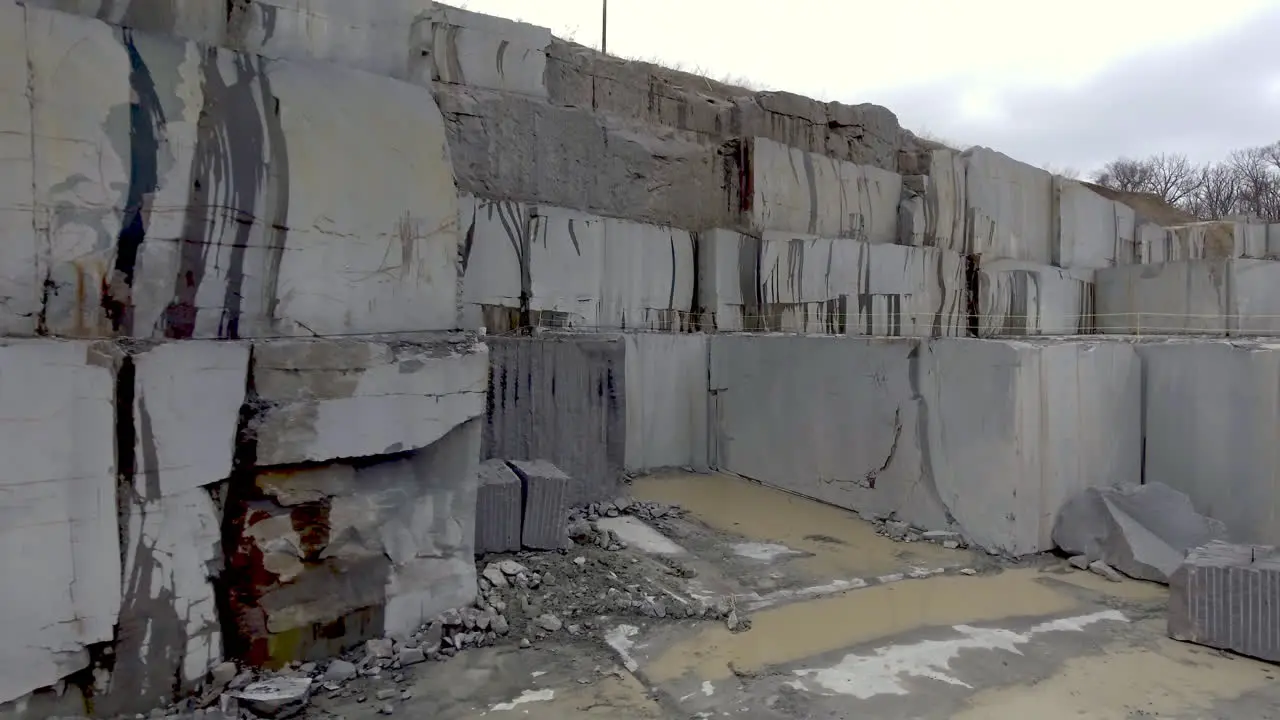 Camera slowly moves forward on giant granite blocks in stone quarry