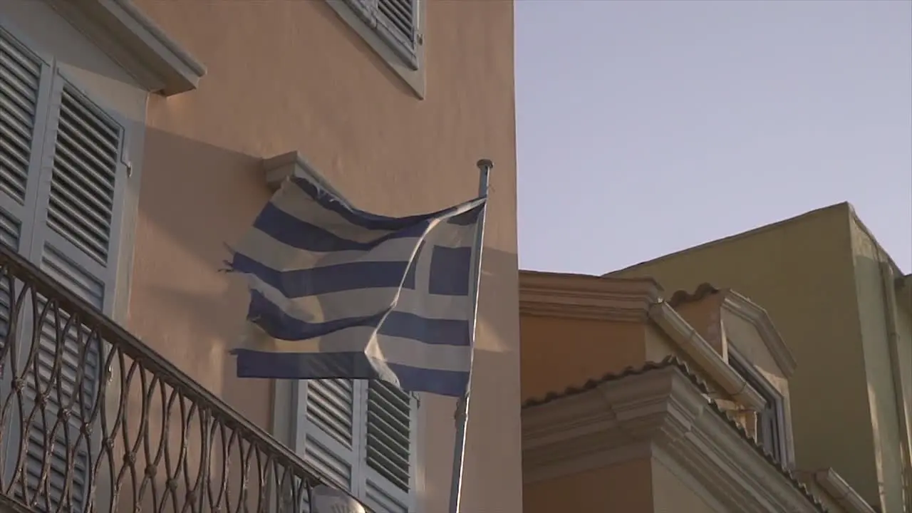 Greece flag on a building is waving in slow motion