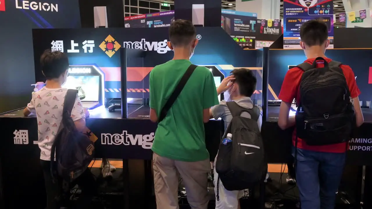 Young Chinese visitors and gamers are seen playing online PC computer video games as gaming and tech fanatics attend the Hong Kong Computer and Communications Festival