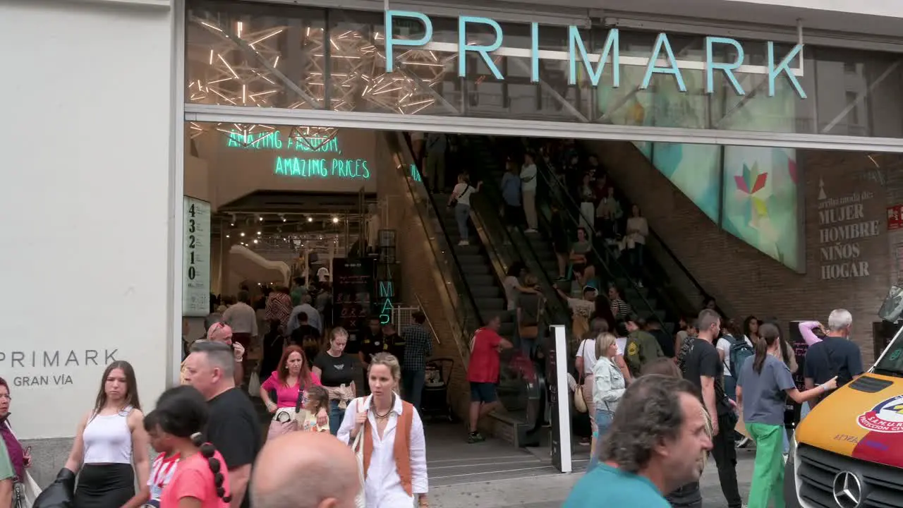 Pedestrians and shoppers are seen in front of the Irish fashion retailer brand Primark store main entrance in Spain