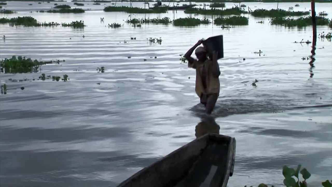 Man carrying a bucket of sand