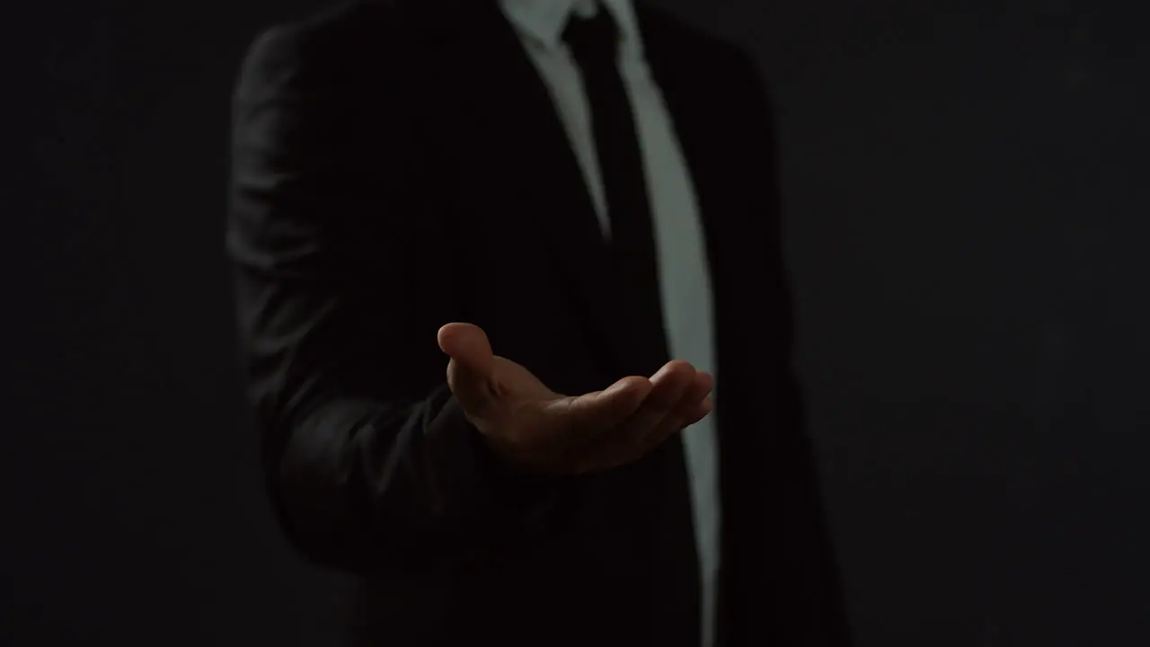 Unrecognizable Arabian Businessman Wearing Suit And Tie Holding A Hand In Front Of Him Like Having Something On The Palm