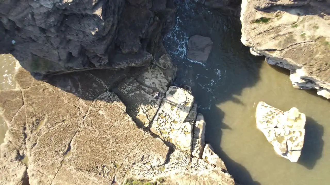 Bird's eye shot of subject with gradual rise to reveal cliffs and coastline of South Shields England