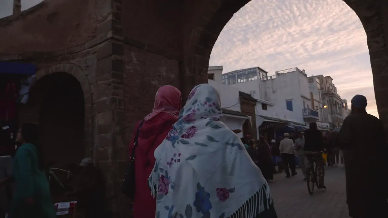 Women wearing headscarves hijab walk through the Medina of Essaouira Morocco port city