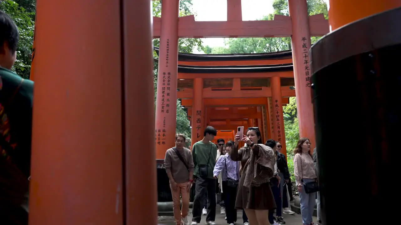 Tourists visit the Fushimi Inari Shrine in Kyoto Japan