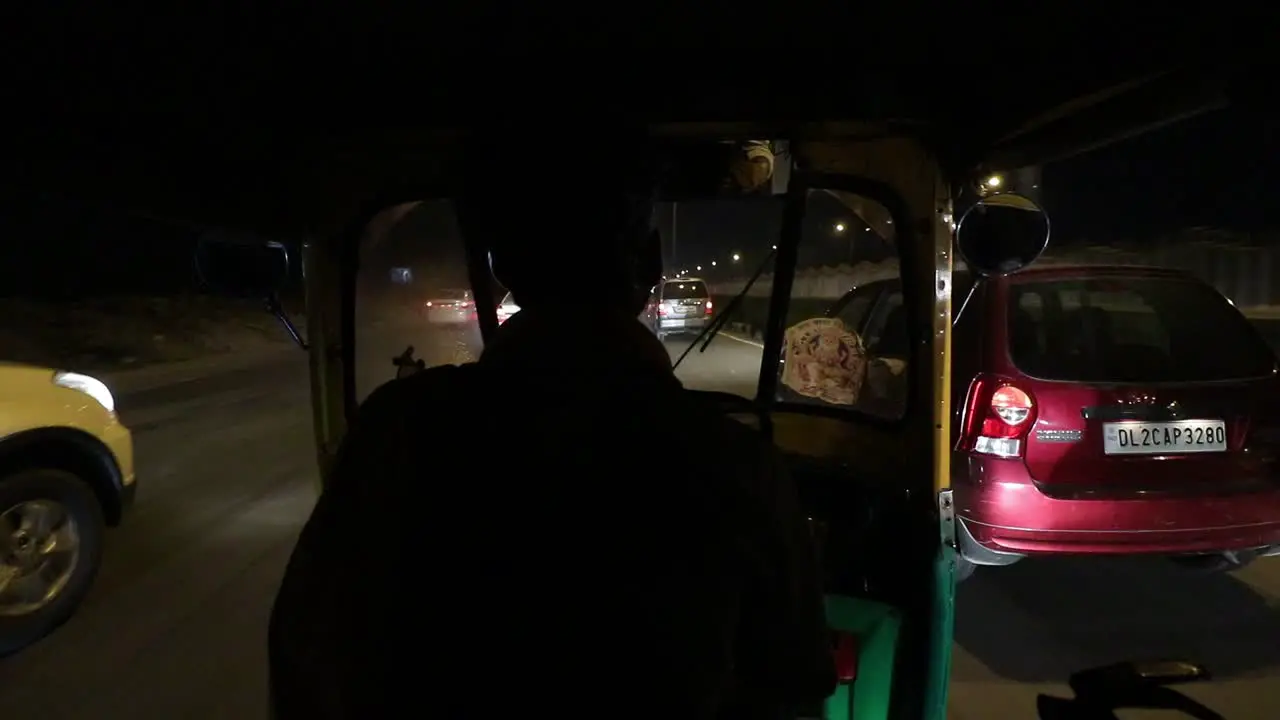 An auto rickshaw driver driving at high speed