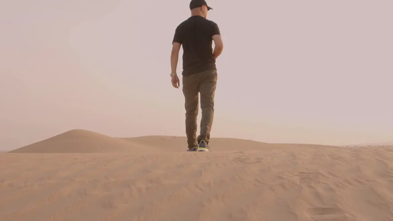 Young man walking in the desert in hostile environment