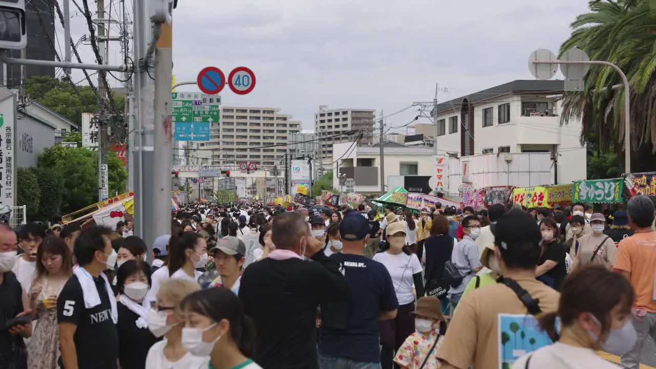 Japanese People Walk Through Streets at Summer Festival