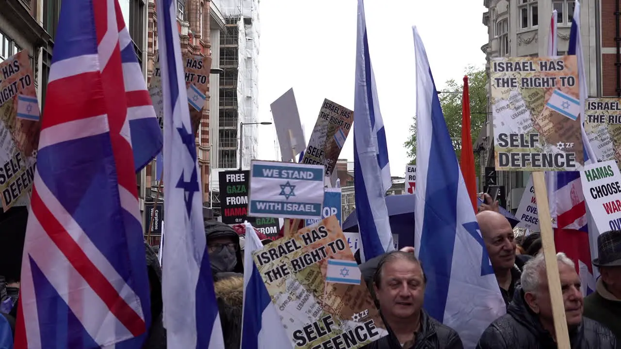 Pro-Israel protestors wave Israeli and British flags and anti-Hamas placards during a pro-Israel protest outside the Israeli embassy in London