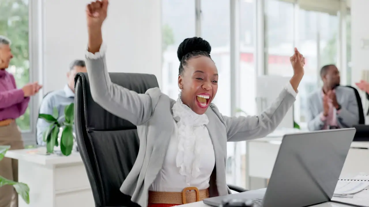 Black woman in office with laptop