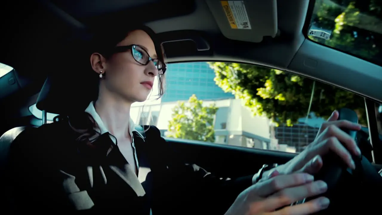 Business woman driving with a neutral expression