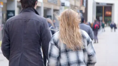 Tracking Shot Following Young City Couple Walking 