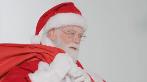 Pedestal Shot of Santa Holding a Sack of Presents