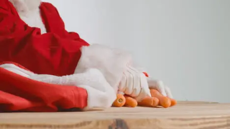 Close Up Shot of Santa Pulling Carrots Out from a Red Sack