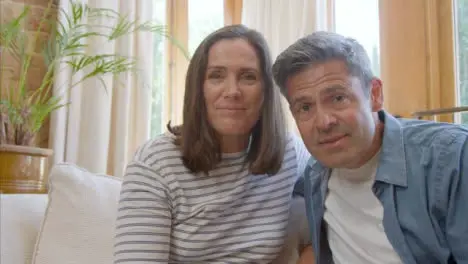 POV Shot of Middle Aged Couple Talking and Waving Goodbye to Camera During Video Call