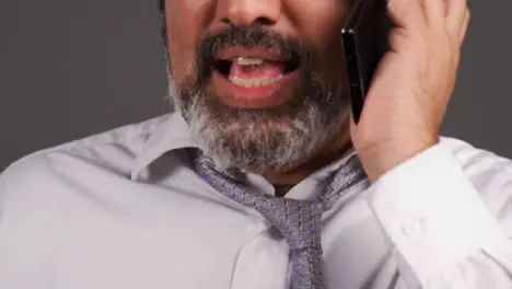 Middle Aged Businessman In Turban Having a Heated Phone Call