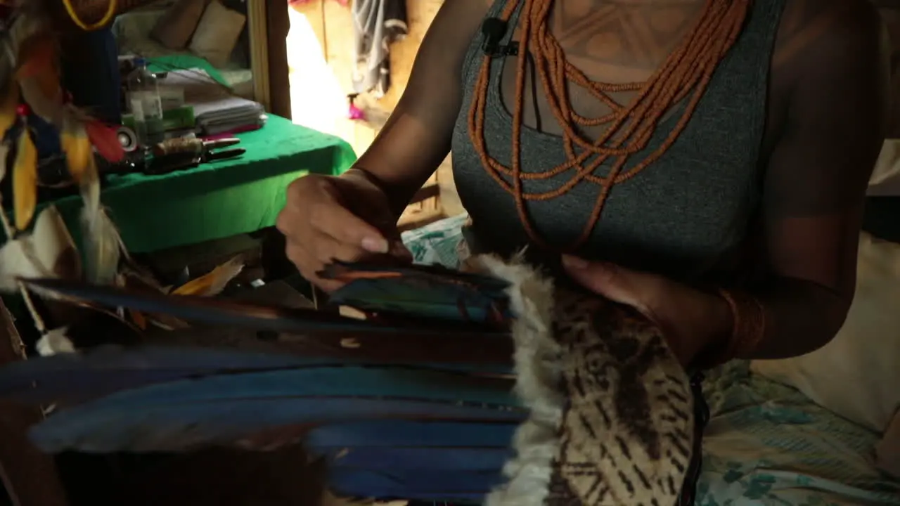 Amazonian tribal healer prepares her headdress before volunteering as a COVID-19 nurse