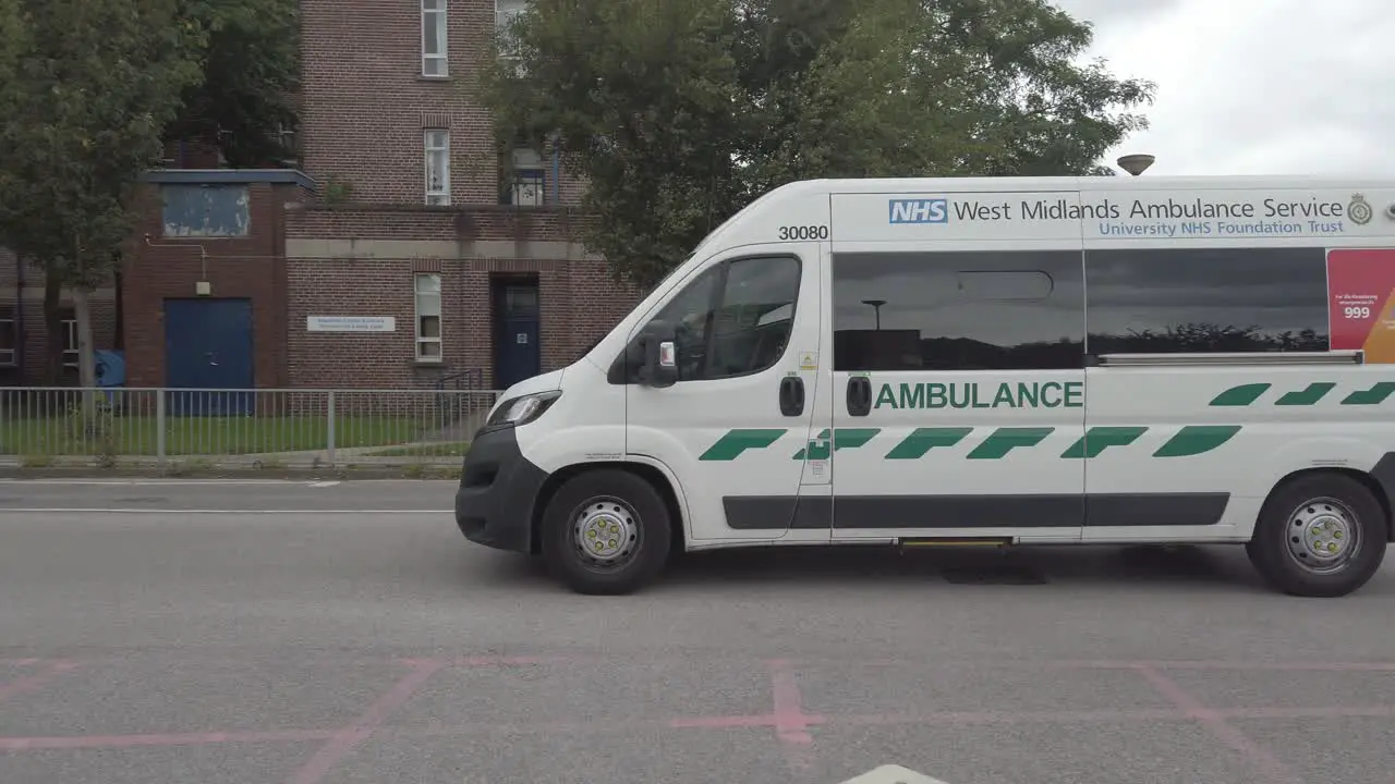 Merseyside white ambulance arriving at Warrington hospital slow motion tracking