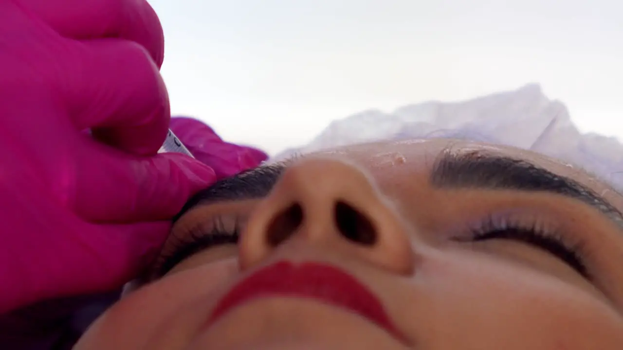 Hispanic woman getting Botox injections close up