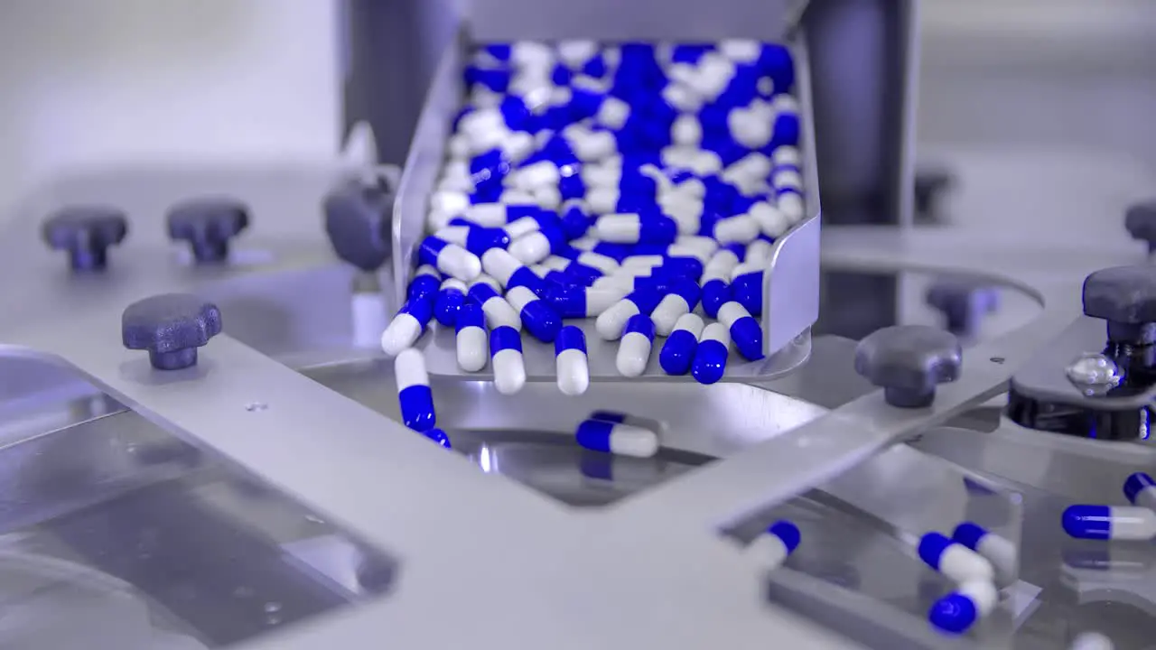 Pills for Coronavirus treatment falling into a spinning plate during its mass production