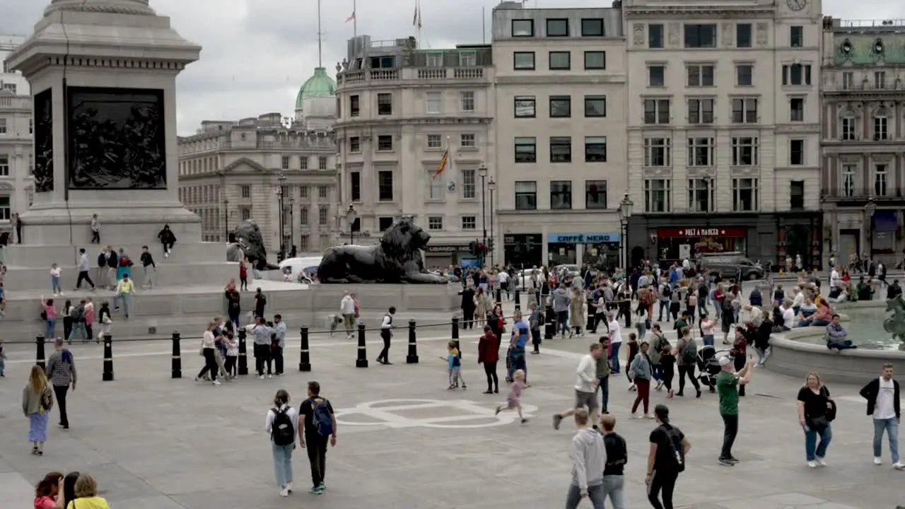 Crowd of people in Trafalgar Square London daytime static view