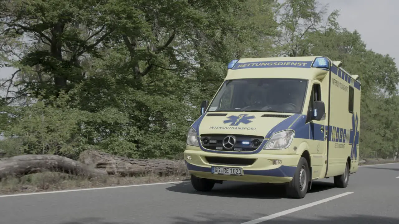 Ambulance using flashing signal passing on highway slow motion