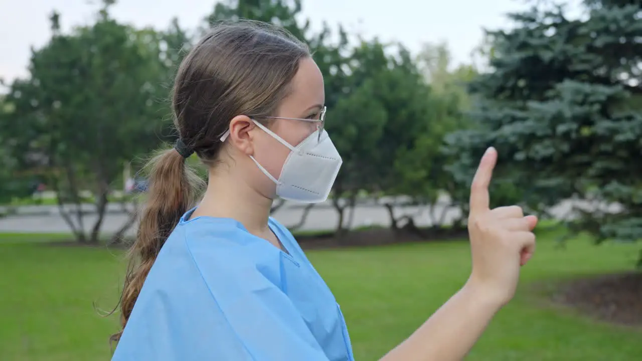 Young nurse with face mask showing NO sign with her hand side view