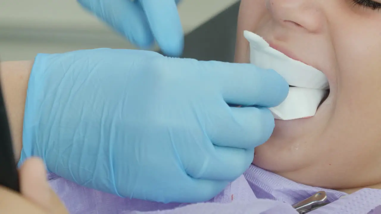 Close-up of a little girl's mouth at the dentist during a dental check and fluoride application