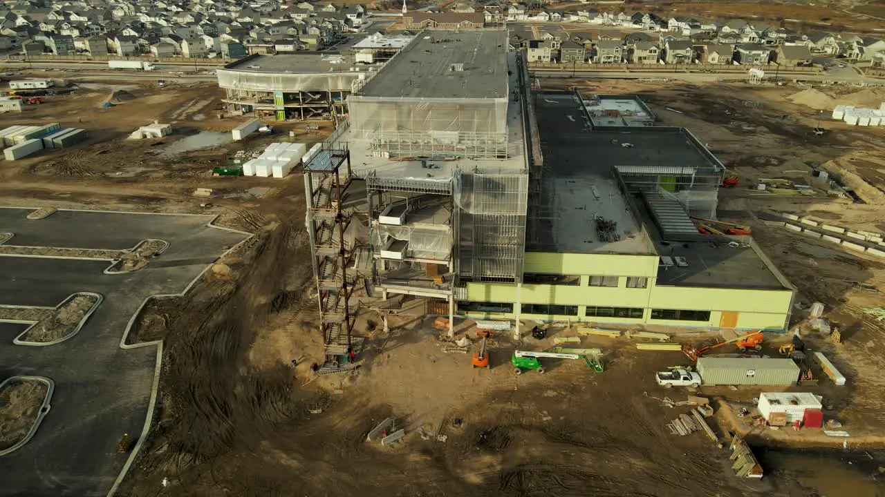 Aerial view of the construction site for the Primary Children's Hospital in Lehi Utah then descent to view the billboard announcement