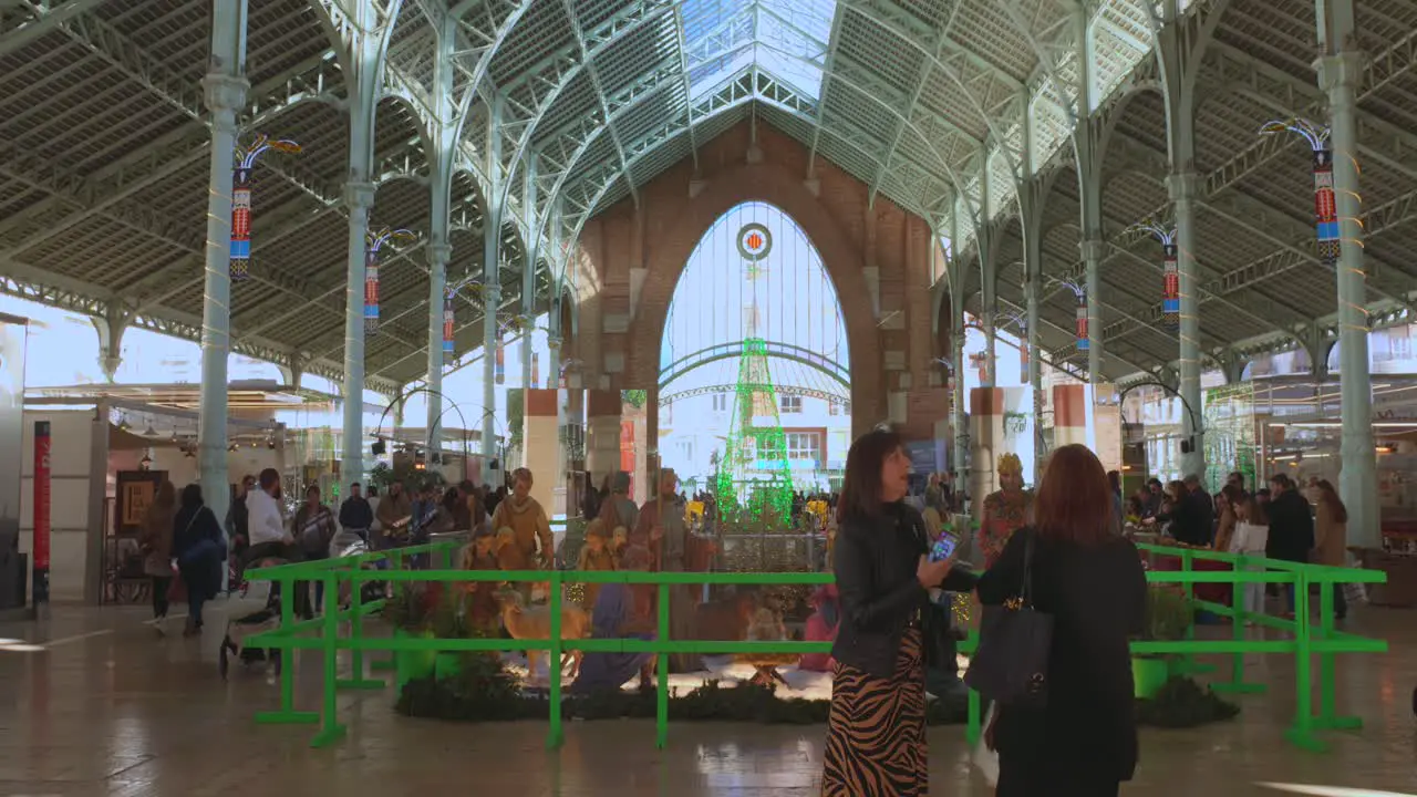 People visiting the large nativity scene Christmas setup at the Market de Colon in Valencia Spain