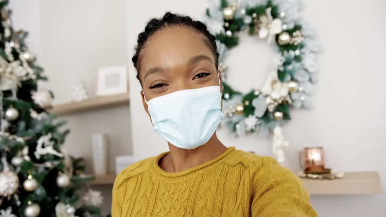 Pov Of Happy Woman In Masks Isolated At Home With Decorated Christmas Tree With Lights Video Chatting Online And Greeting Friends And Relatives With Xmas