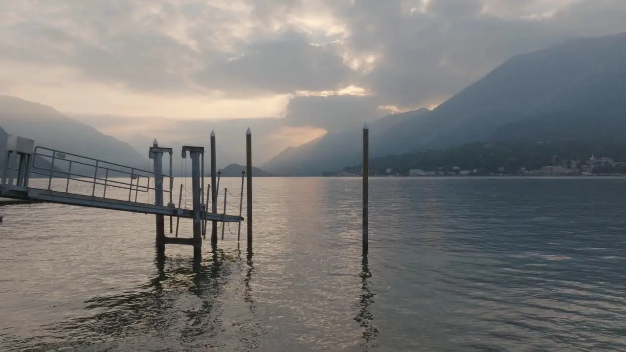 4K Aerial Sunset shot pushing through morring poles low and slow over the lake in Bellagio Lake Como Italy