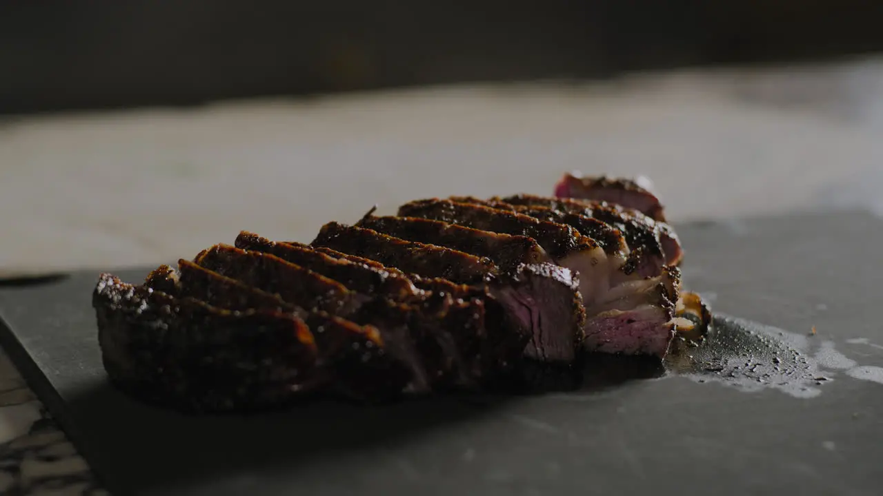 Sliced steak sitting on a cutting board