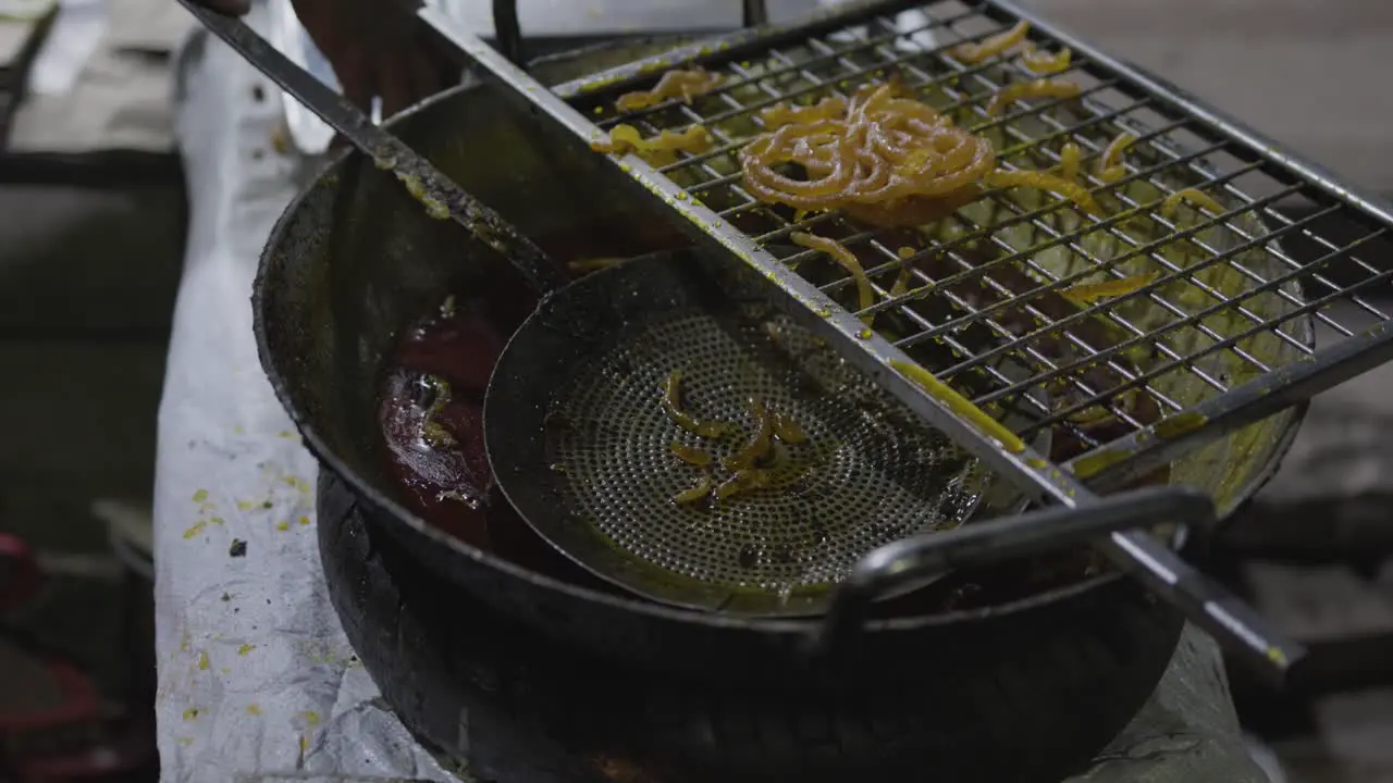 indian traditional sweet jalebi in sugary syrup from flat angle