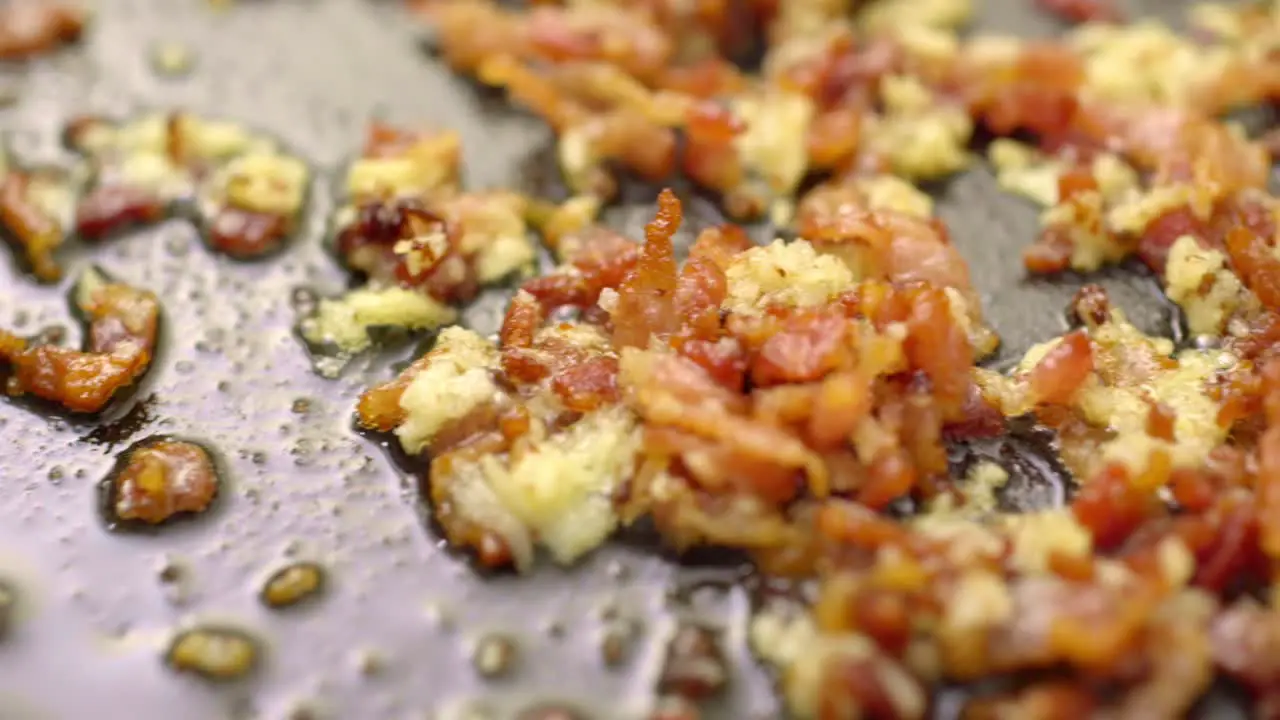 bacon food is being fried in a pan