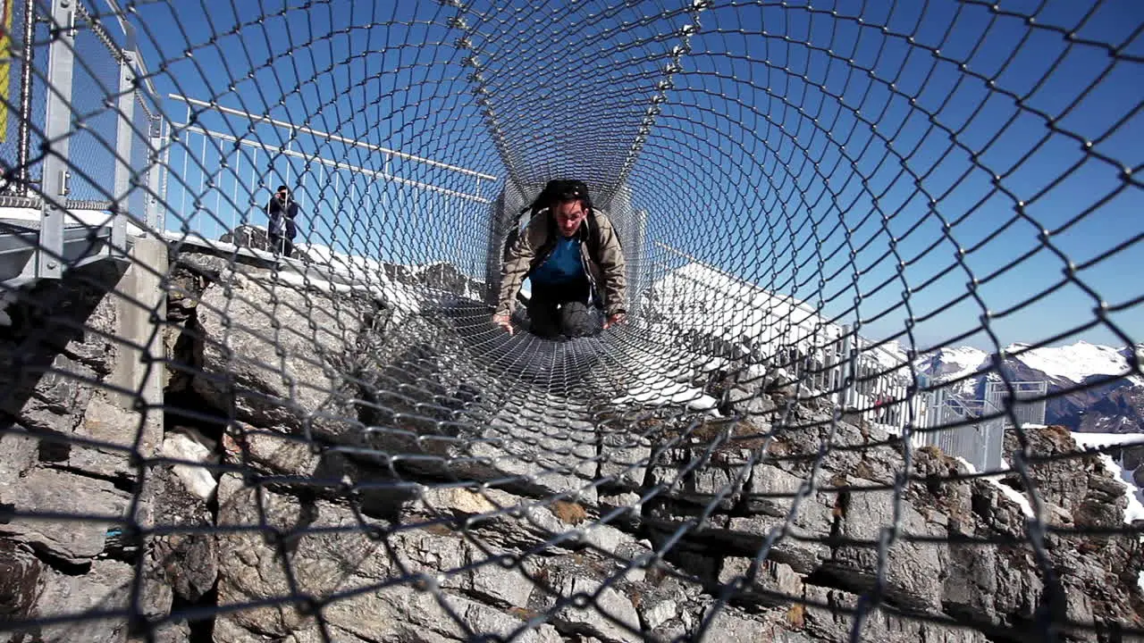 Climbing steel cage tunnel Swiss alps heights