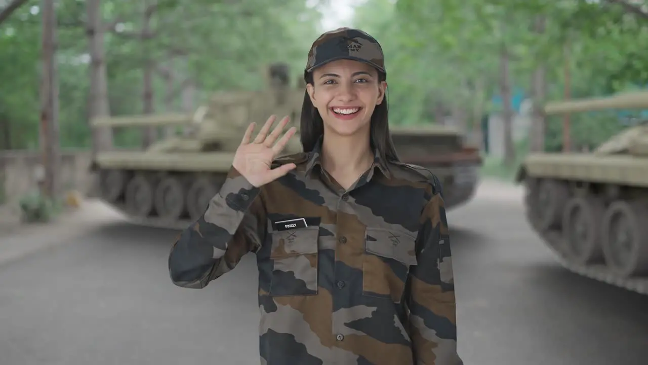 Happy Indian woman army officer waving Hi