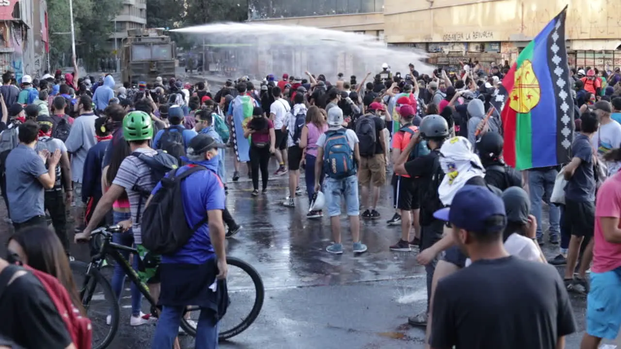 Crowd of rioters chant at oncoming military police armored truck