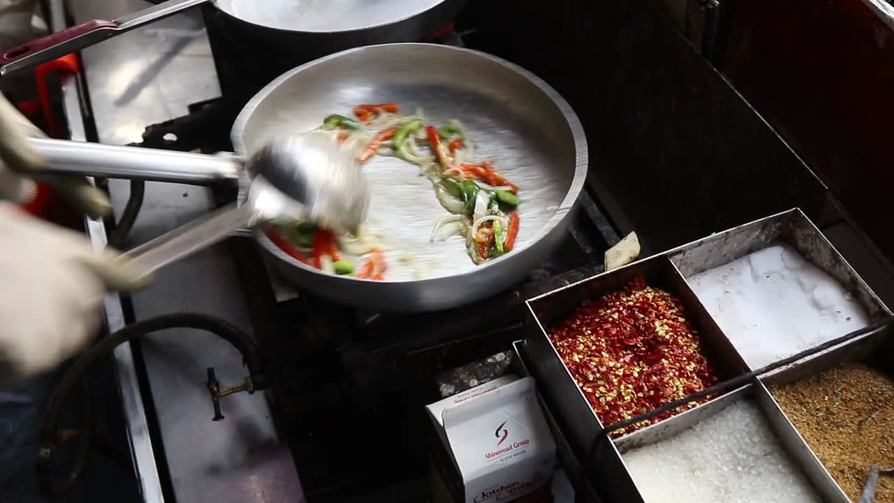 Professional chef prepares white sauce Pasta at a street food shop at Chat Gali in Agra India on 07 March 2021