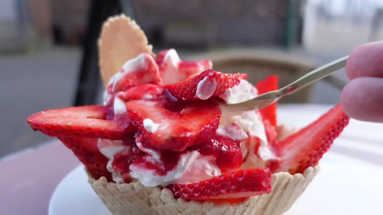 Eating strawberry ice cream close up