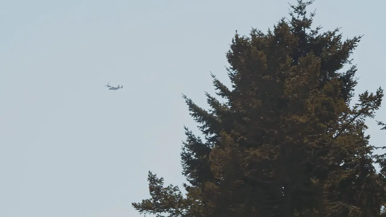 Two V-22 Osprey Military Tilt Rotor Planes Passing By In The Distance